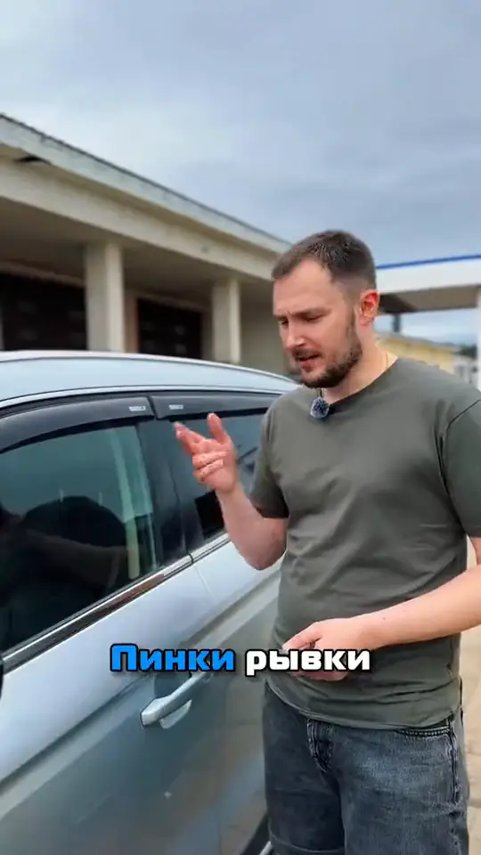 Кадр из ролика: мастер стоит у автомобиля и рассказывает о неисправностях коробки